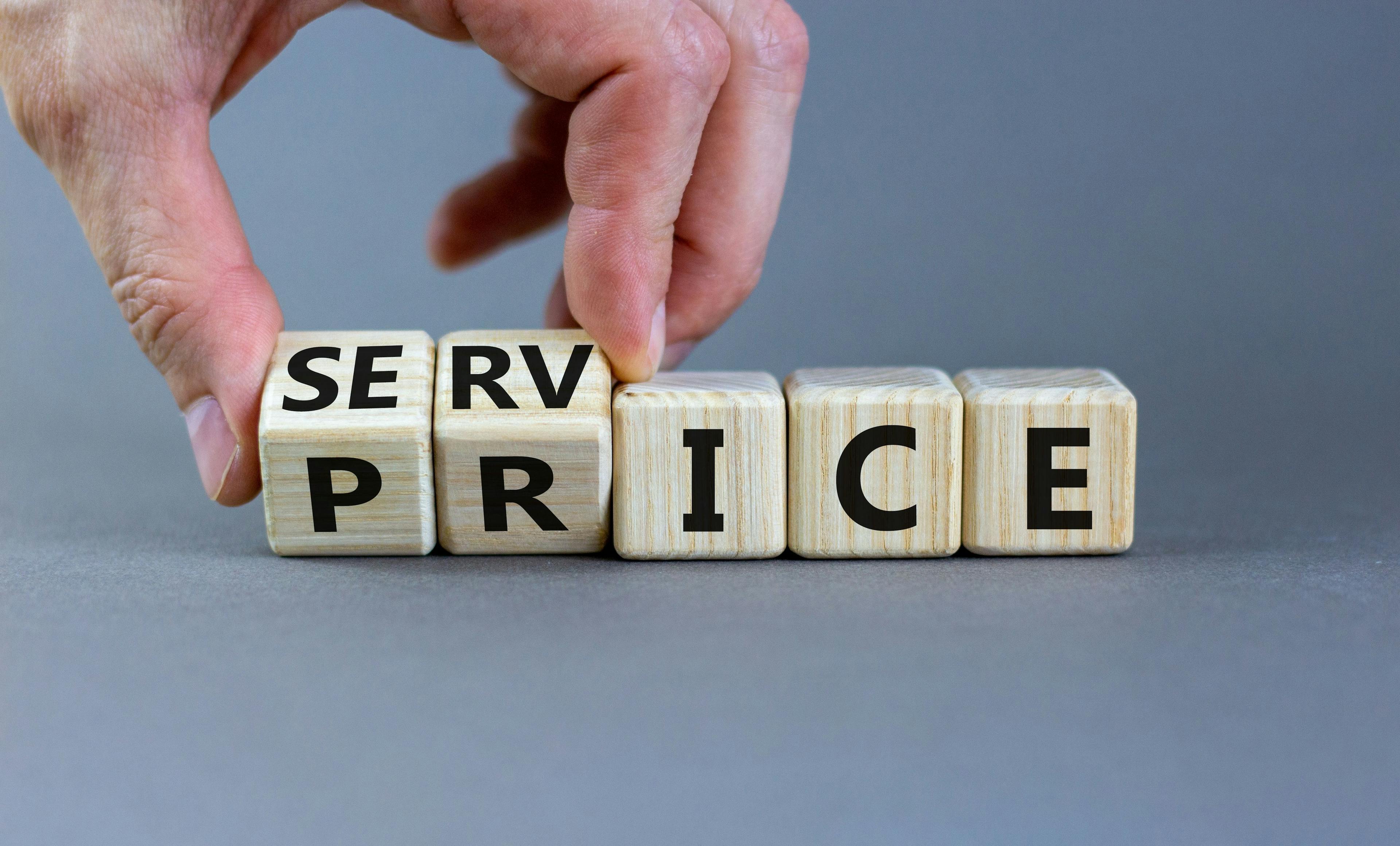 Wooden cubes spelling out "service price" on a white background.