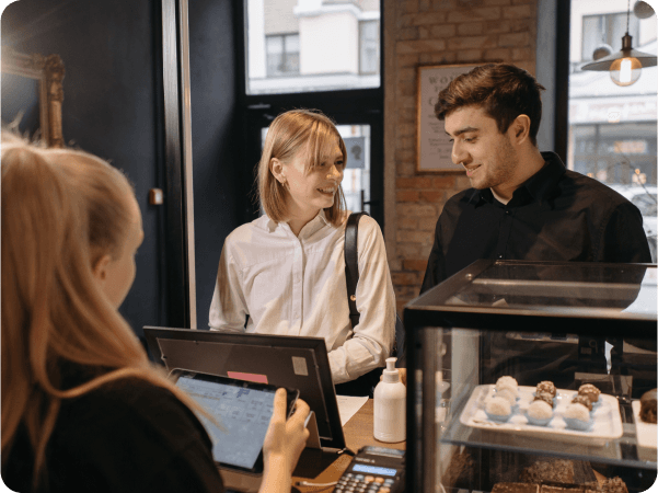 Seamless order sending from FineDine to POS Integrations with man and woman in front of computer.