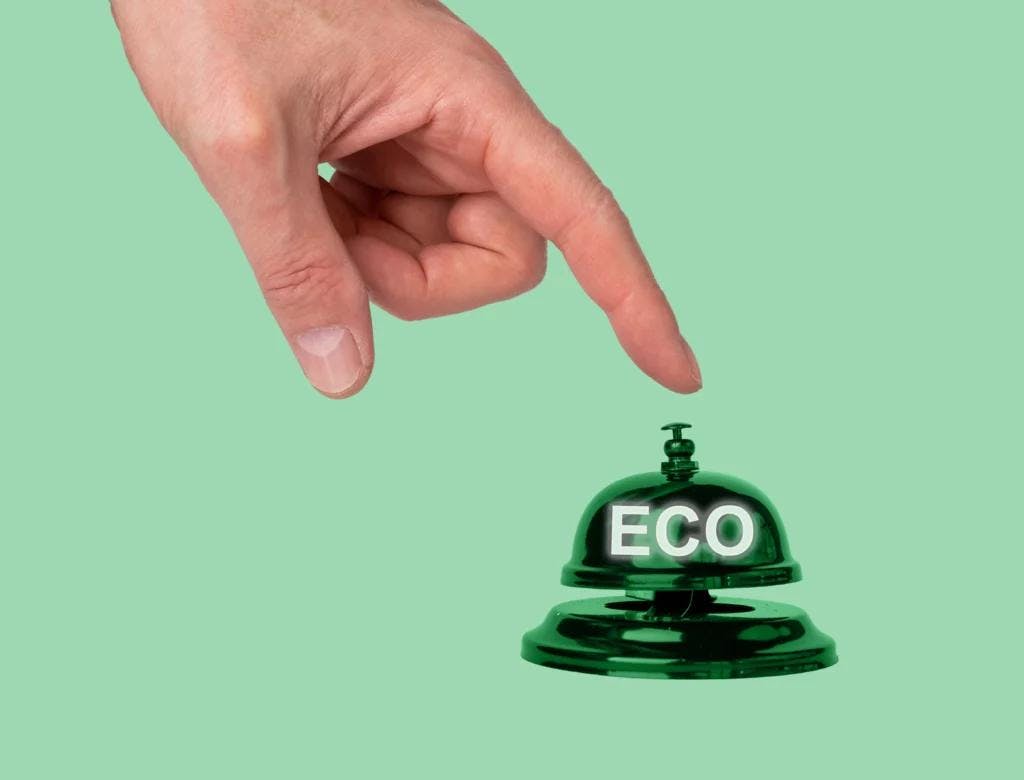 A green hotel bell, symbolizing eco-friendliness and sustainability. A great asset for digital marketing campaigns.