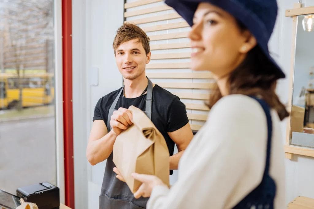 A man and woman in front of a door, perhaps contemplating food waste.