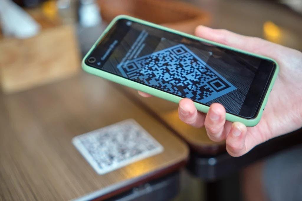 Mobile payment trend at restaurants with QR code scanning.